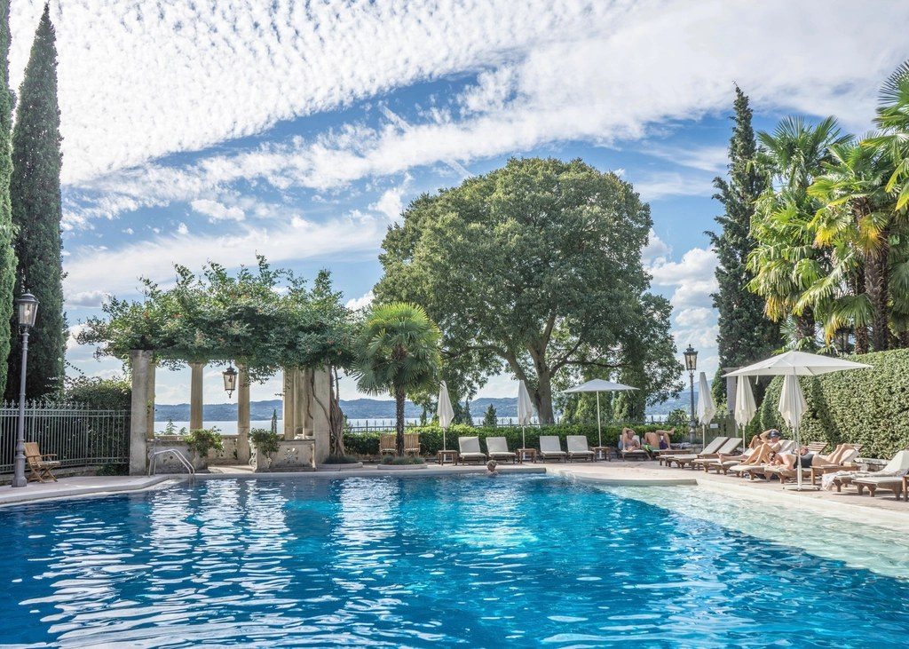 Clear blue pool surrounded by trees